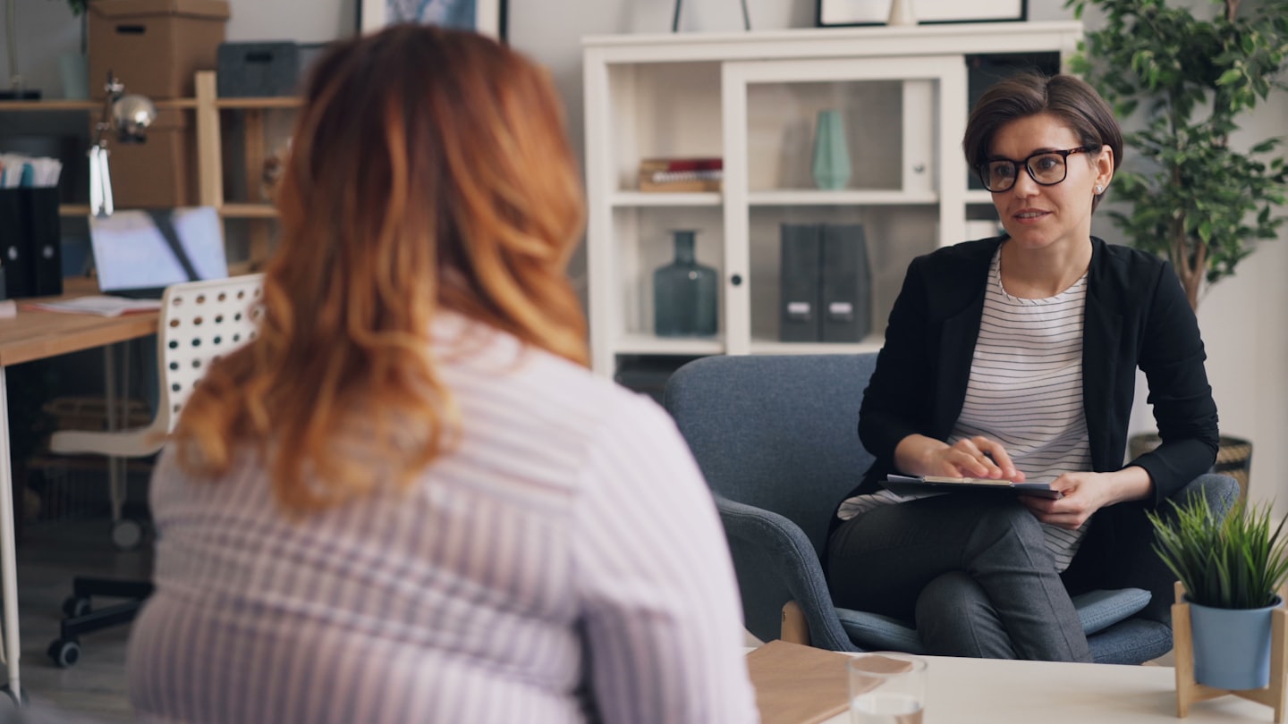 Two women in a professional consultation session in a bright office.